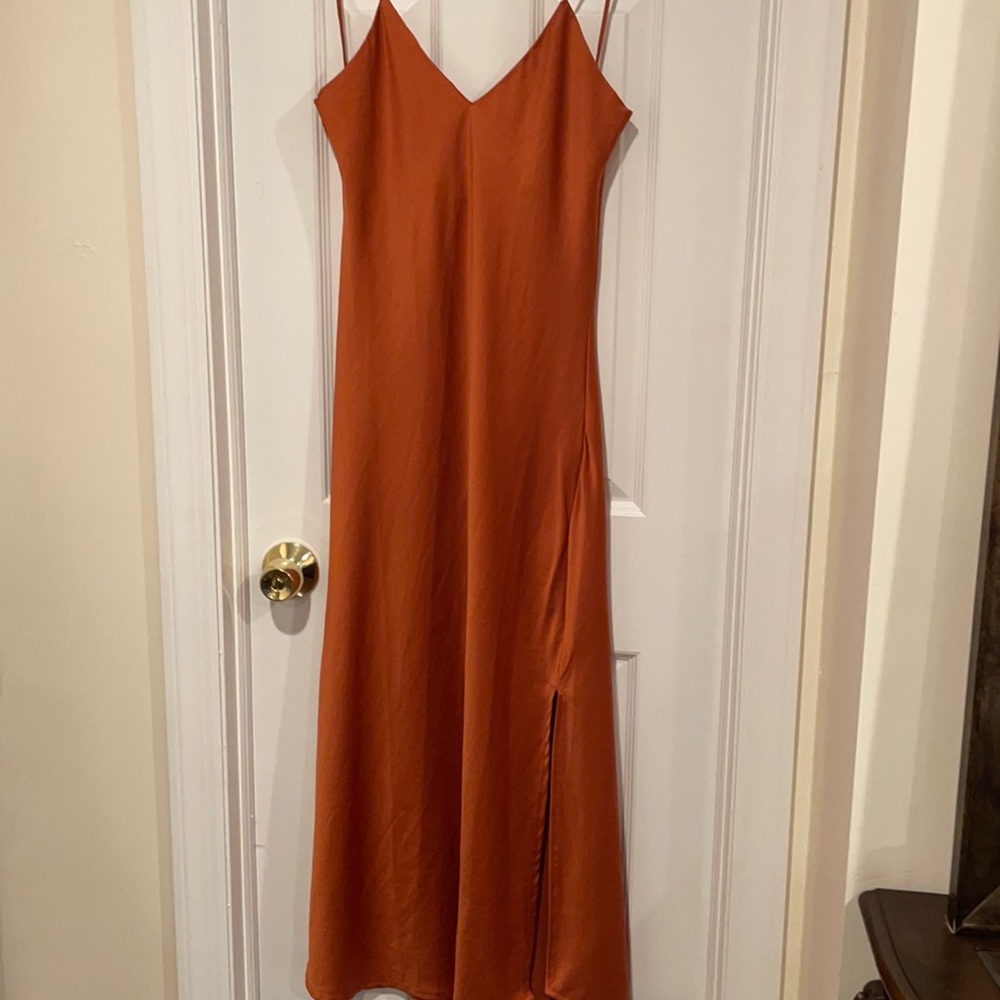 Pretty burnt orange silky spaghetti strap dress with two side slits going up leg
